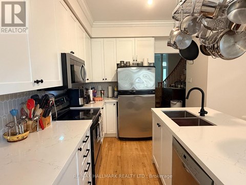 A kitchen with white cabinets and a stainless steel dishwasher.
