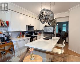 A kitchen with a white countertop and a hanging pot rack.