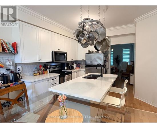 A kitchen with a white countertop and a hanging pot rack.
