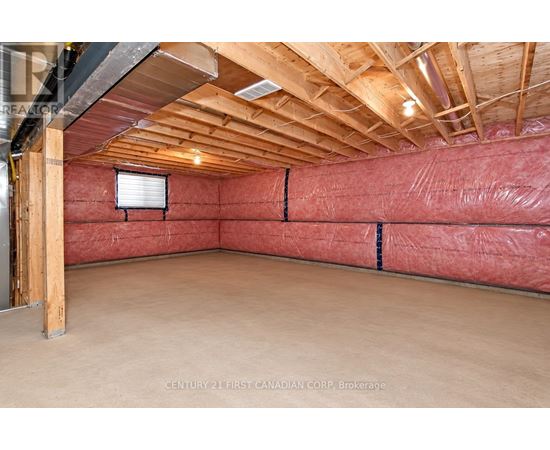 A room with a red wall and wooden ceiling.