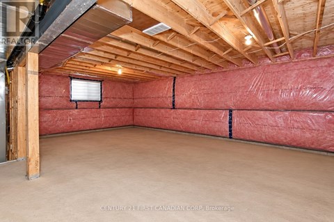 A room with a red wall and wooden ceiling.