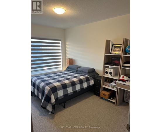 A bedroom with a bed and a shelf with various items on it.