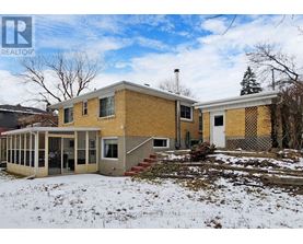 A house with a yellow brick exterior is for sale.