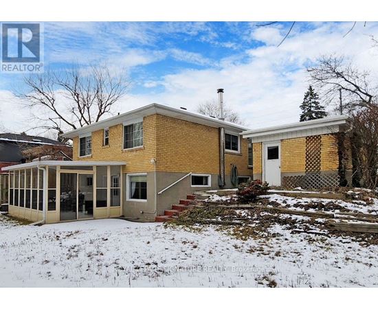 A house with a yellow brick exterior is for sale.