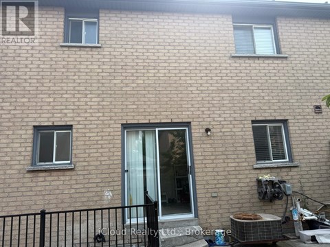 A brick building with a black fence in front.