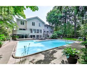 A large house with a pool in the backyard.