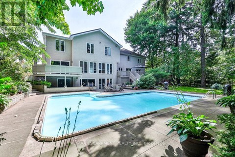 A large house with a pool in the backyard.