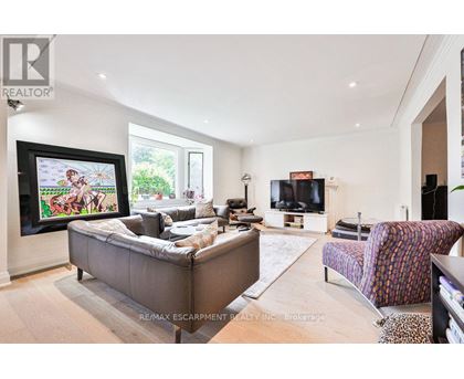 A living room with a grey couch and a television.