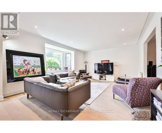 A living room with a grey couch and a television.