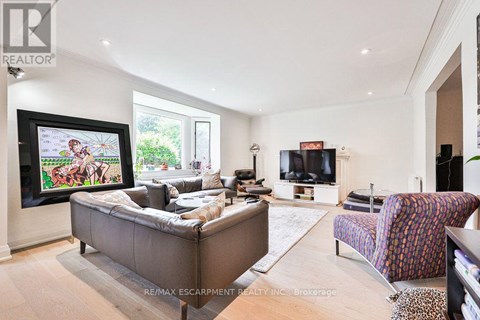 A living room with a grey couch and a television.