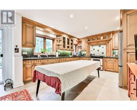 A kitchen with wooden cabinets and a large island in the middle.
