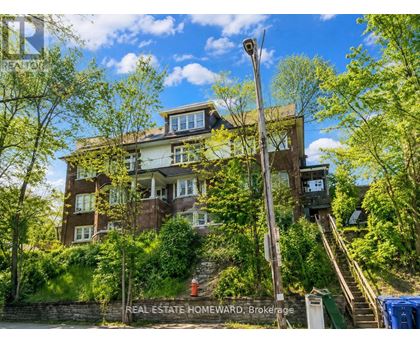 A large brown house with a staircase leading up to it.
