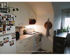 A small kitchen with a white fridge and a white stove.