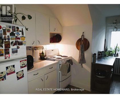 A small kitchen with a white fridge and a white stove.