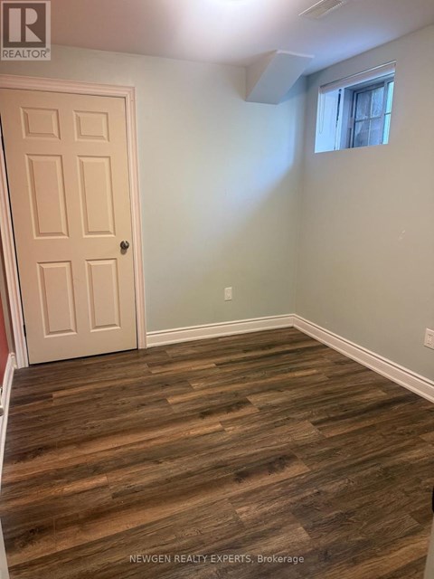 A room with a wooden floor and a white door.