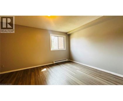 A room with a window and wooden flooring.