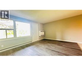 A room with a window and a door is available for rent.
