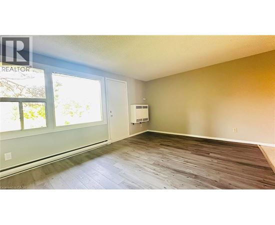 A room with a window and a door is available for rent.