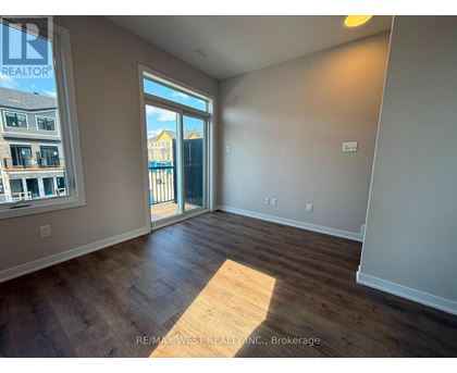 A room with a sliding glass door leading to a balcony.