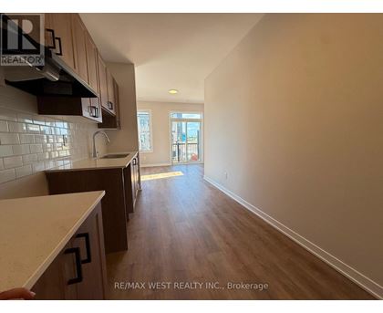 A kitchen with wooden cabinets and a countertop is shown.