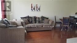 A living room with a couch and a chair.
