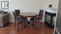 A dining room with a table and chairs.