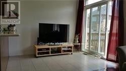 A living room with a flat screen TV on a wooden stand.