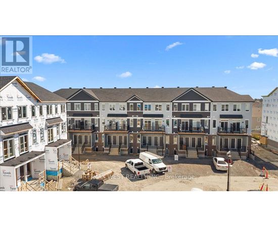 A construction site with a building under construction and a completed building in the background.