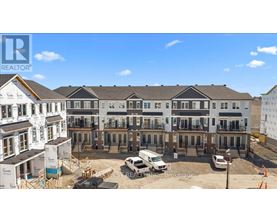 A construction site with a building under construction and a completed building in the background.