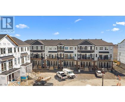 A construction site with a building under construction and a completed building in the background.
