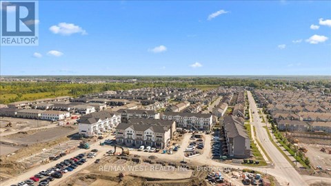A real estate company logo is displayed on a large image of a housing development.