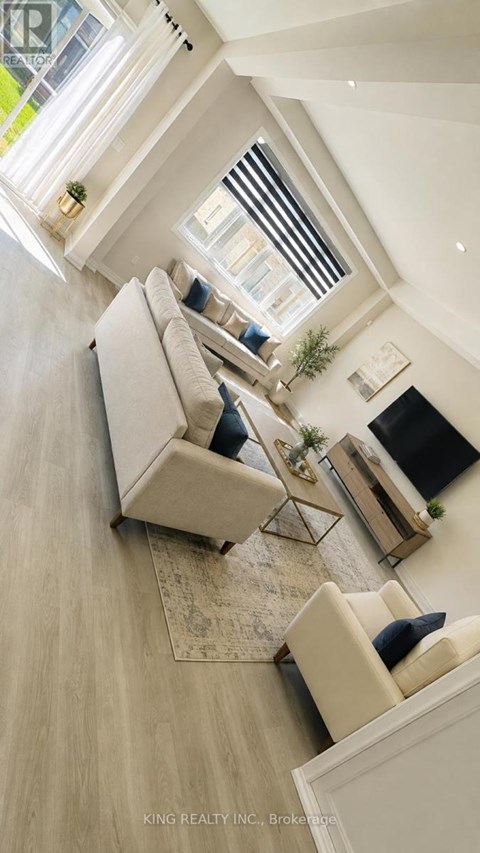 A well-lit living room with a couch, a coffee table, and a rug.