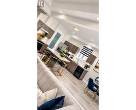 A modern kitchen with a dining area and a living room.