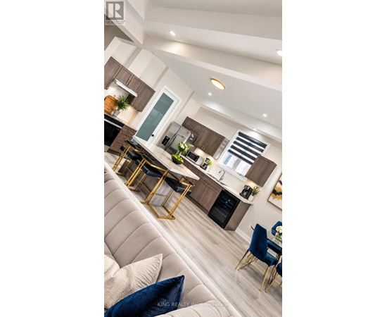 A modern kitchen with a dining area and a living room.