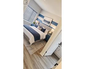 A bedroom with a bed, a mirror, and a cabinet.