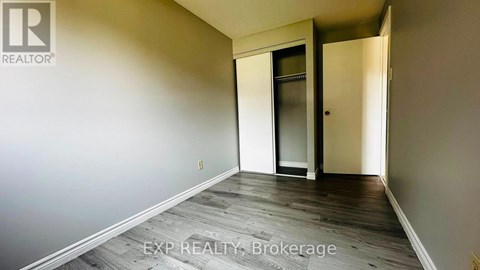 A room with a door and a wall with a logo.