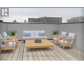 A wooden deck with a sofa, chairs and a table.