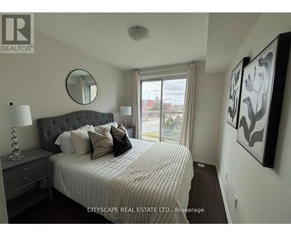 A bedroom with a large bed, a mirror, and a painting on the wall.