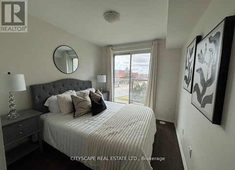 A bedroom with a large bed, a mirror, and a painting on the wall.