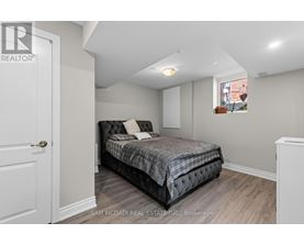 A bedroom with a bed, a window, and a door.