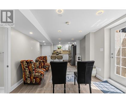 A real estate office with a desk and chairs.