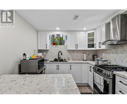 A kitchen with a stove top oven and a microwave.