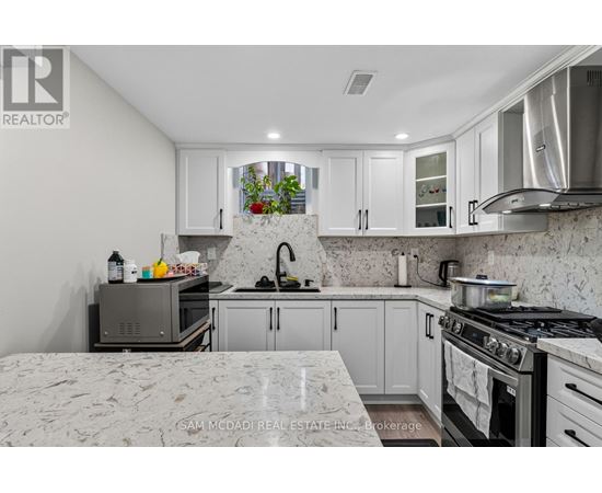 A kitchen with a stove top oven and a microwave.