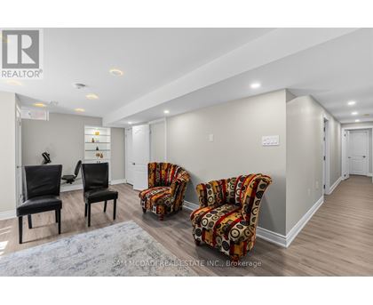 A living room with two chairs and a couch.
