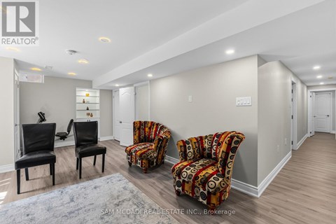 A living room with two chairs and a couch.