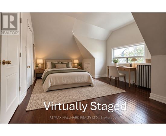 A bedroom with a bed, a chair, and a window.