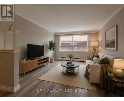 A living room with a television, a couch, and a coffee table.