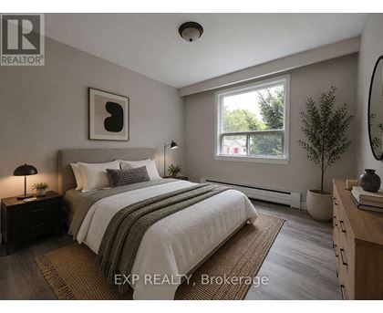 A bedroom with a bed, nightstand, and window.