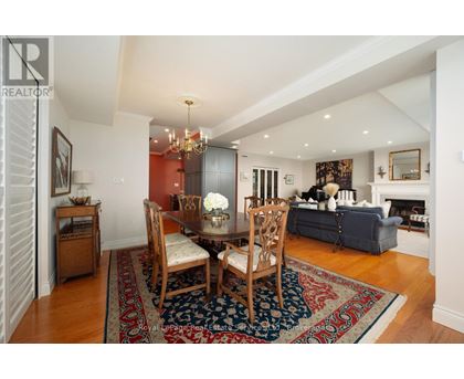 A living room with a dining table and chairs.