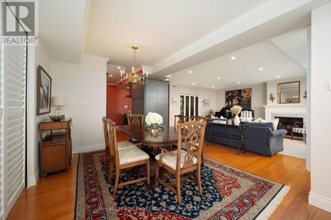 A living room with a dining table and chairs.